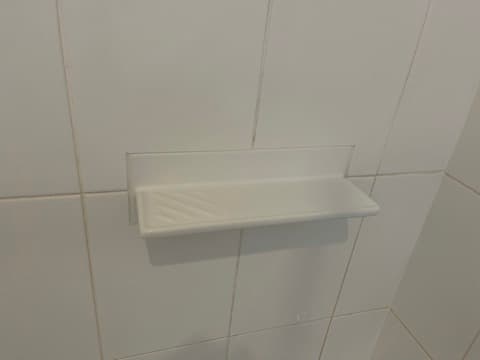 Finished ceramic shower shelf